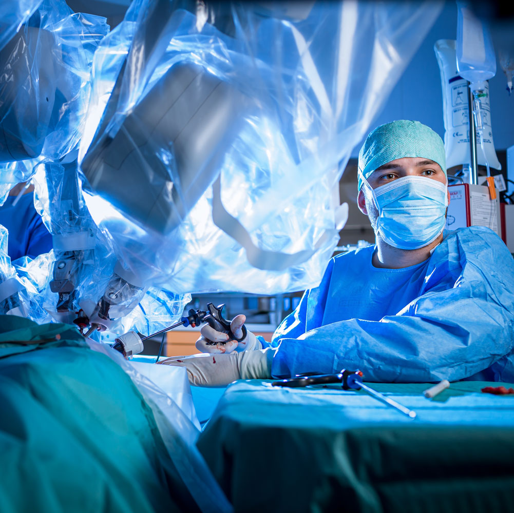 A surgical team working at the bedside during robotic surgery.